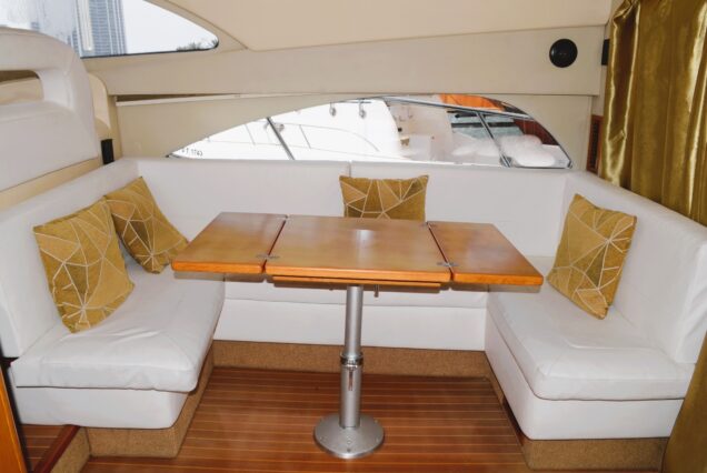 Rodman 44FT salon lounge with table Dubai Marina rental